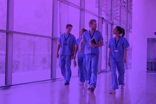 Healthcare workers in a hospital corridor