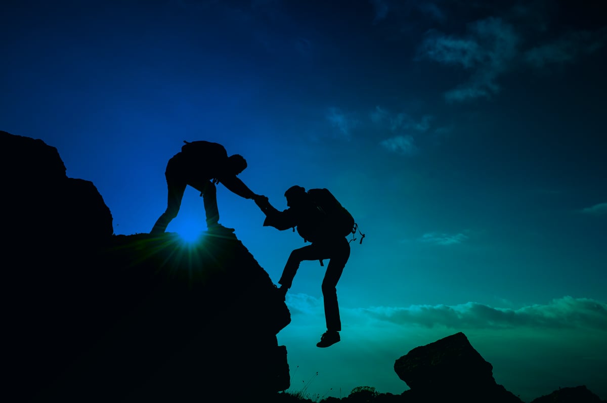 Climber reaching the summit, representing advancing a process automation plan